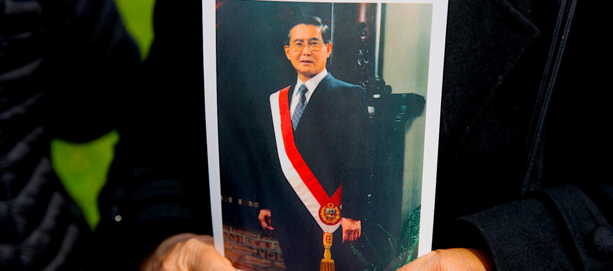 Una simpatizante del fallecido presidente de Perú Alberto sostiene un retrato de Fujimori en una fila para ingresar al velatorio este jueves, en el Ministerio de Cultura en Lima (Perú). El Gobierno peruano decretó desde este jueves un duelo nacional, que se prolongará por tres días, debido a la muerte del expresidente Alberto Fujimori, fallecido el miércoles a los 86 años. EFE/ Paolo Aguilar