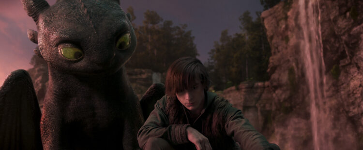 (from left) Night Fury dragon, Toothless, and Hiccup (Mason Thames) in Universal Pictures’ live-action How to Train Your Dragon, written and directed by Dean DeBlois.